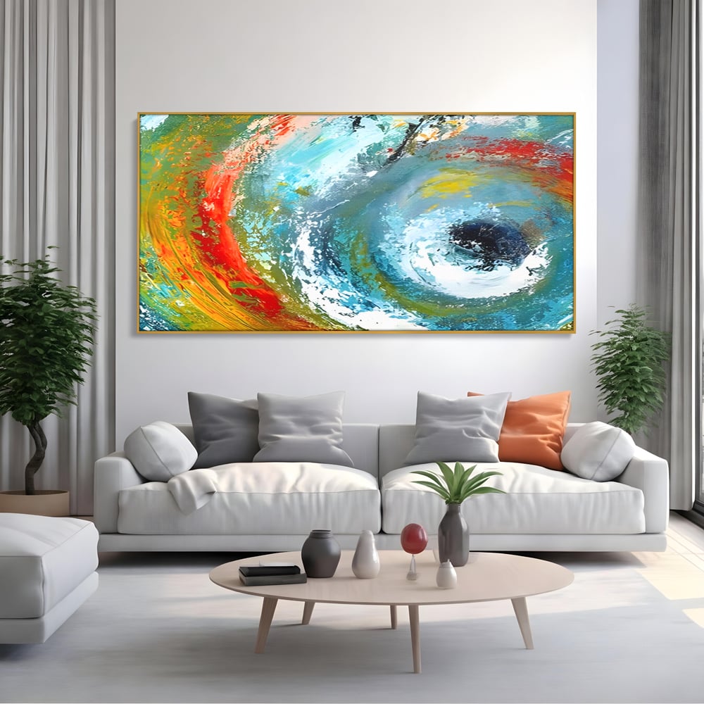 Tablou canvas cu pictura abstracta cu vartej de culori, in rama de aluminiu auriu, pe perete intr-un living